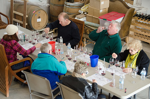 Image of a wine blending class, tasting their mixed wines.